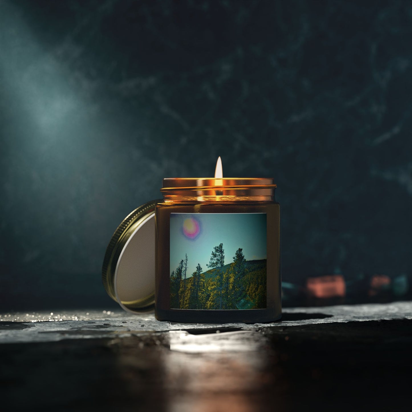 Candle in a jar with a scenic picture on a dark background