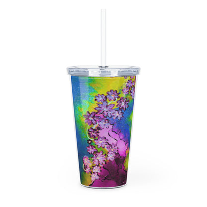 Colorful floral-patterned tumbler with a straw on a white background