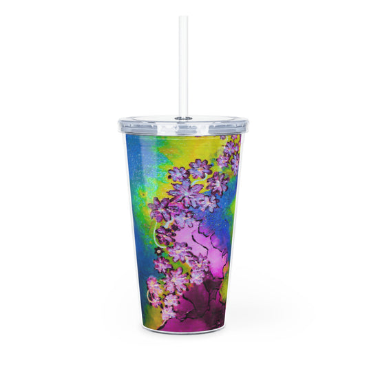 Colorful floral-patterned tumbler with a straw on a white background