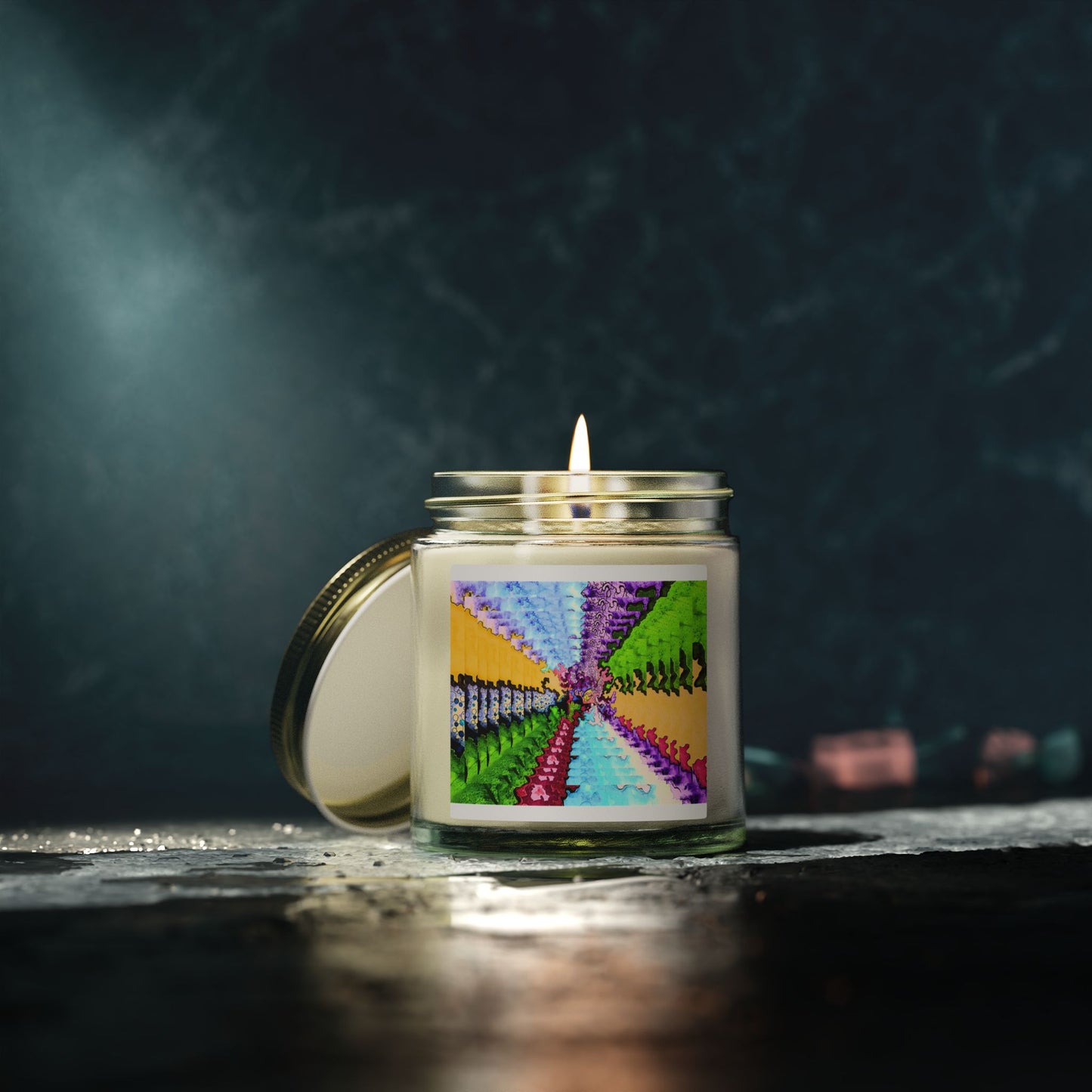 Candle in a glass jar with a colorful label on a dark background