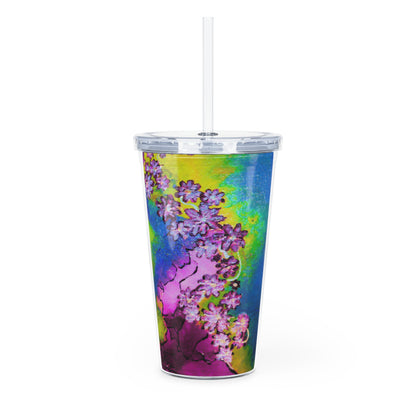 Colorful tumbler with floral design and straw on a white background
