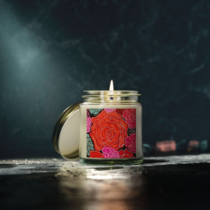 Candle in a glass jar with a colorful rose label on a dark background