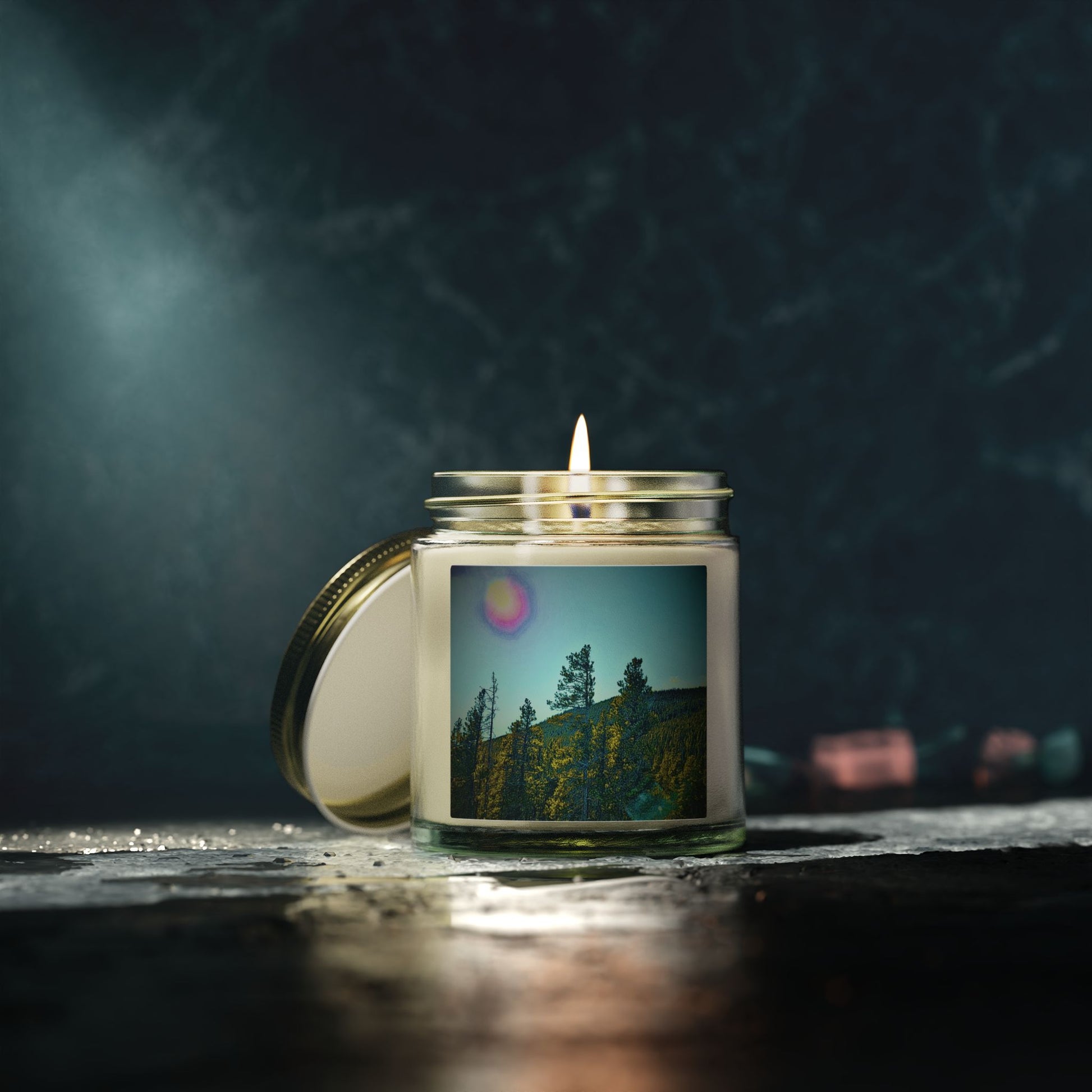 Candle in a jar with a scenic label on a dark background