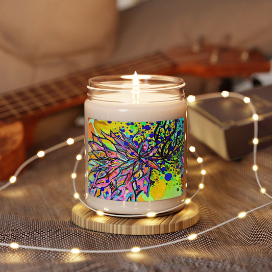 Candle with a colorful label on a wooden coaster surrounded by string lights and a guitar in the background