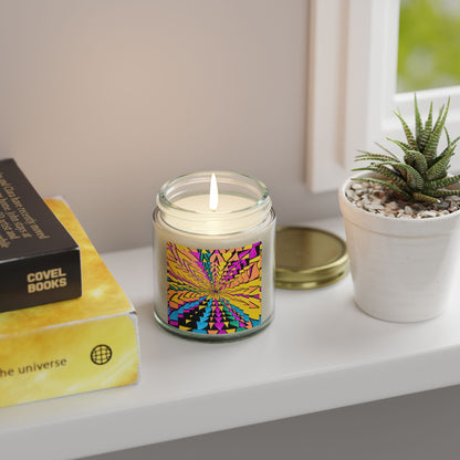 Candle with colorful design on a windowsill next to books and a plant