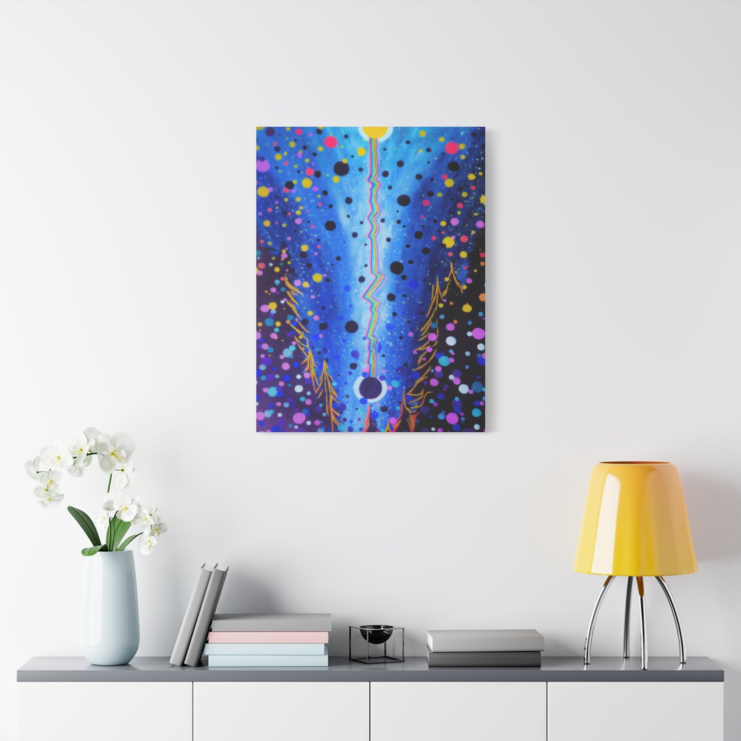 Abstract painting on a wall above a table with decor items