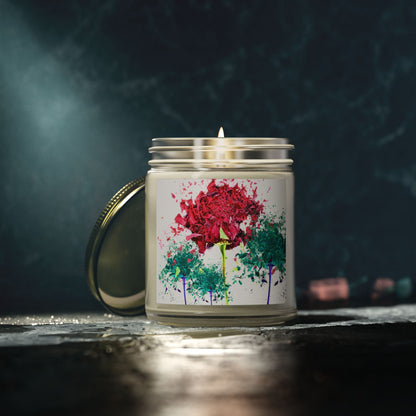 Candle with a colorful floral design on the label against a dark background