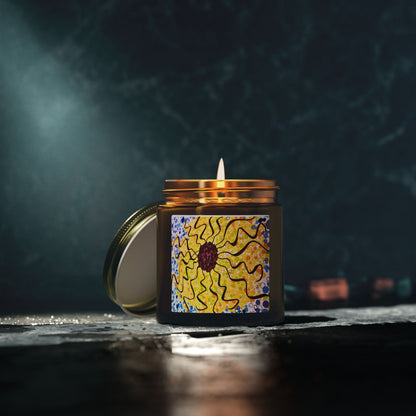 Candle in a decorative jar with a sun design on a dark background