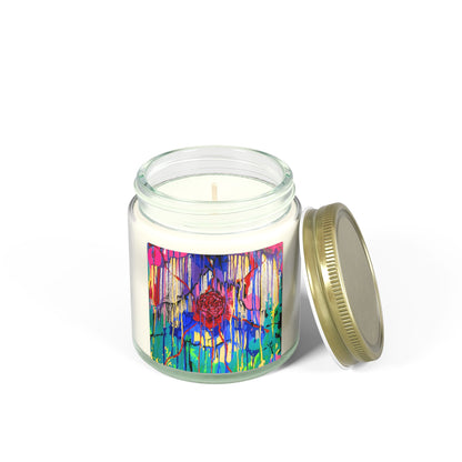 Candle in a glass jar with a colorful label and gold lid on a white background