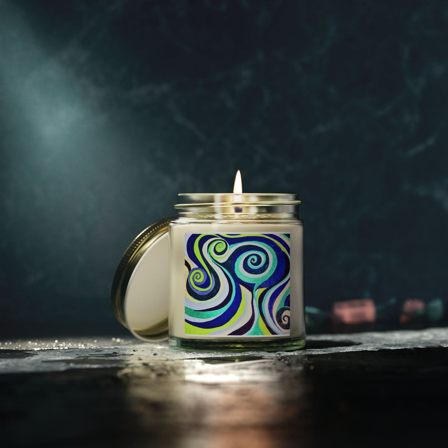 Candle with a colorful label on a dark background