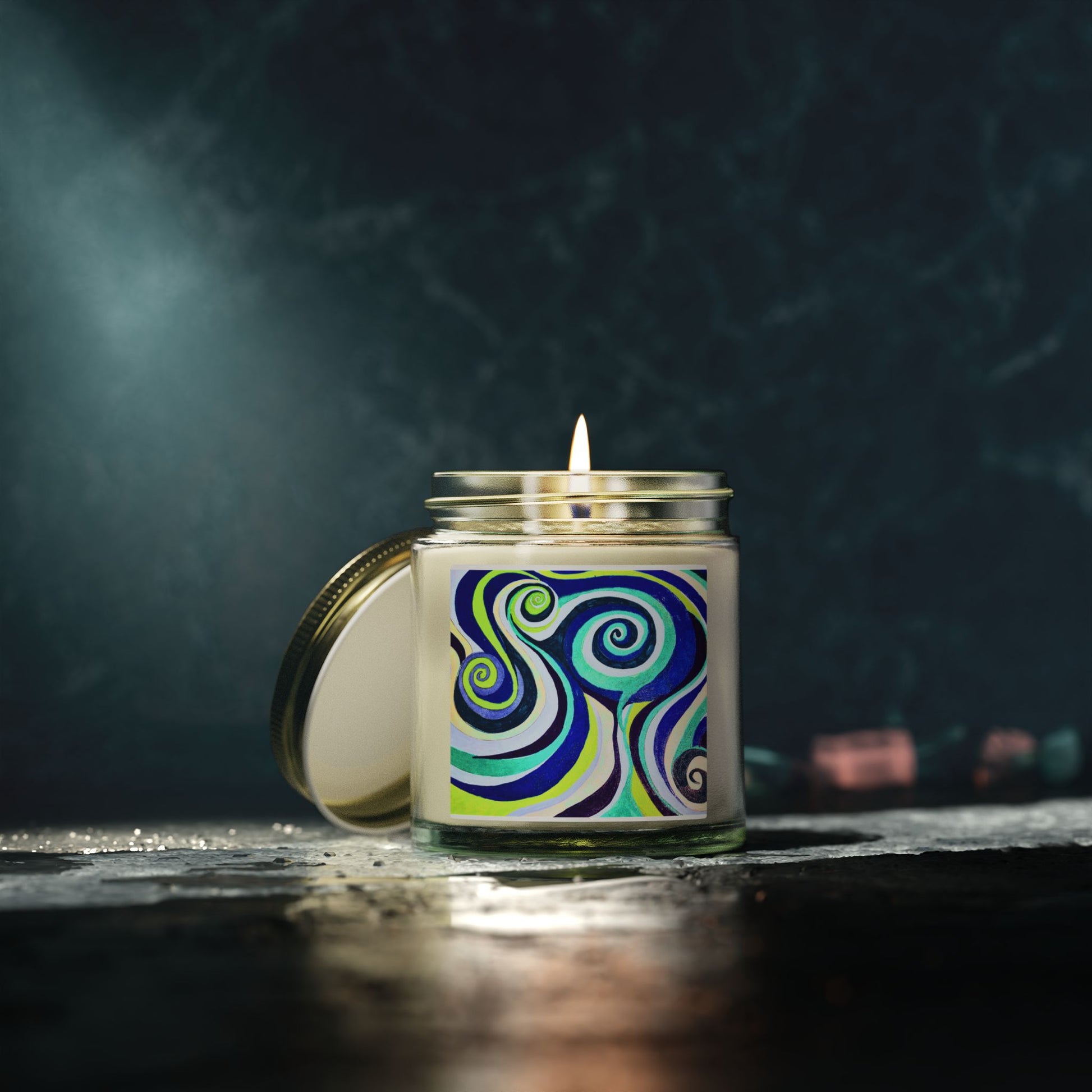 Candle with a colorful label on a dark background
