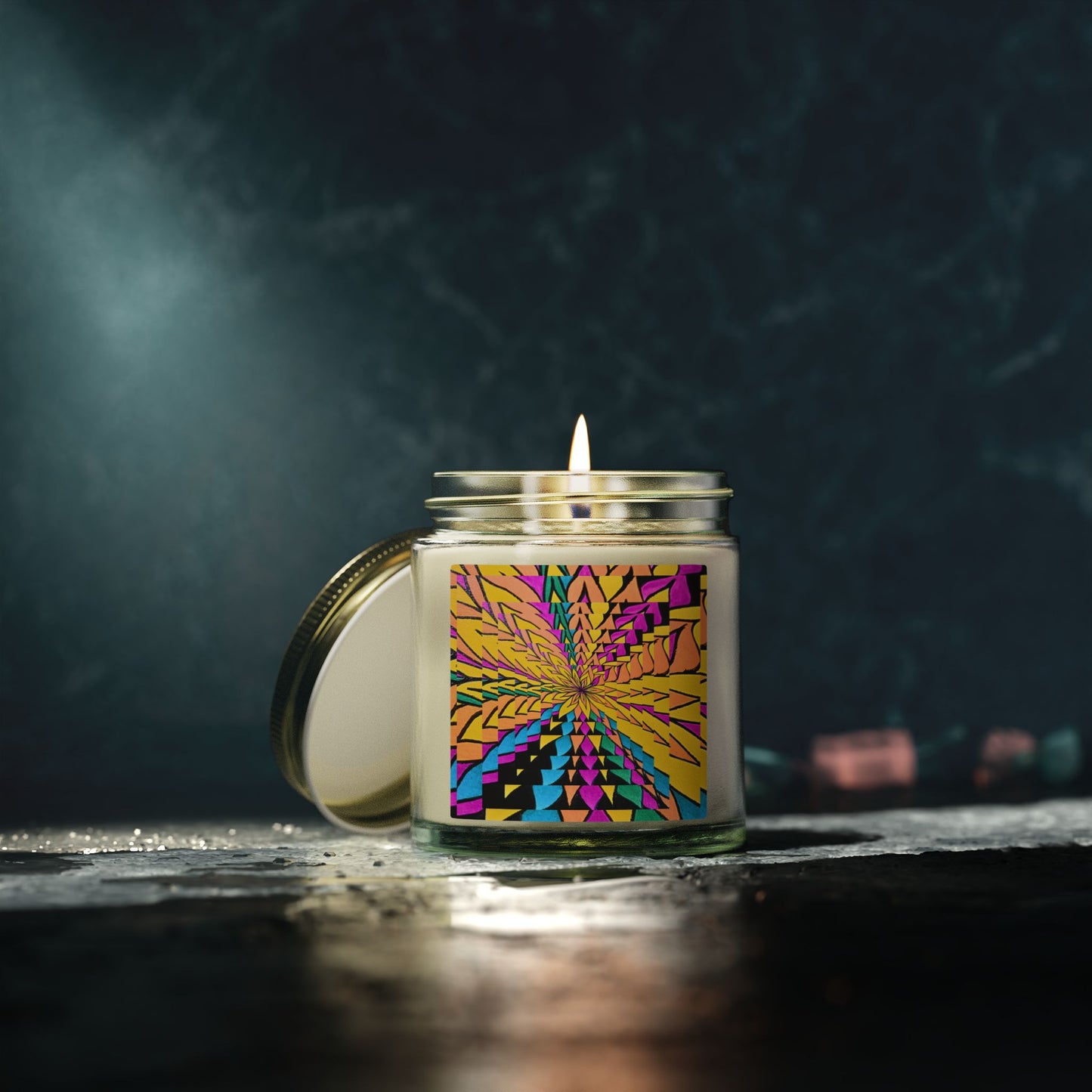 Candle in a glass jar with a colorful label on a dark background