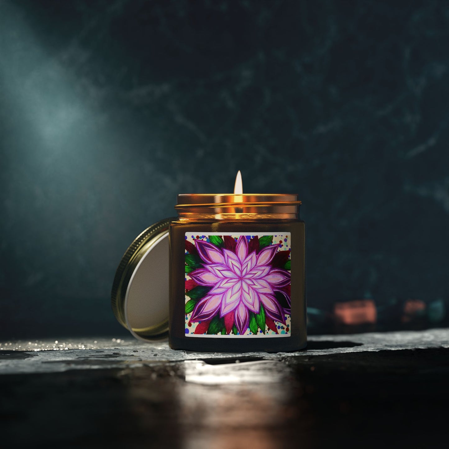Candle with a colorful floral design on the label against a dark background