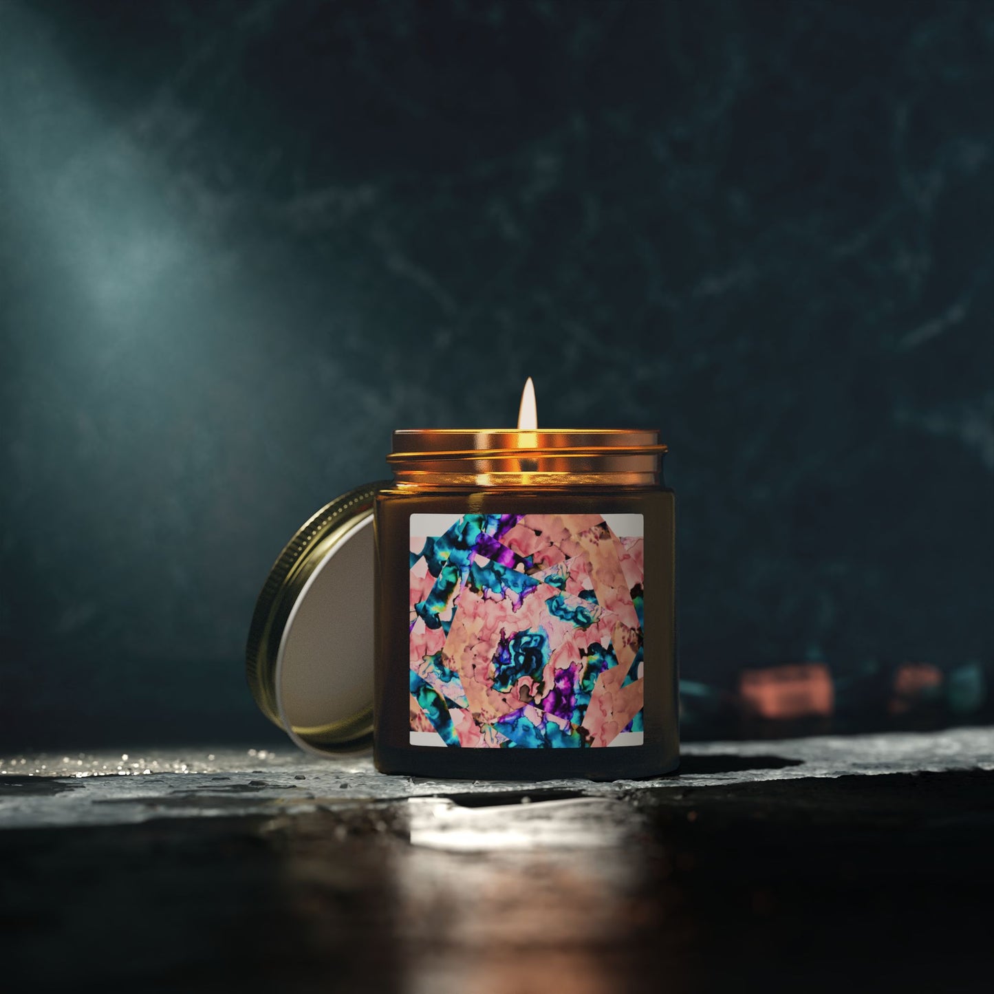 Candle in a decorative jar with a colorful label on a dark background