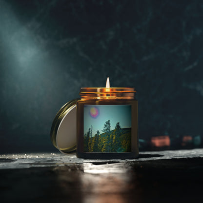 Candle in a jar with a scenic picture on a dark background