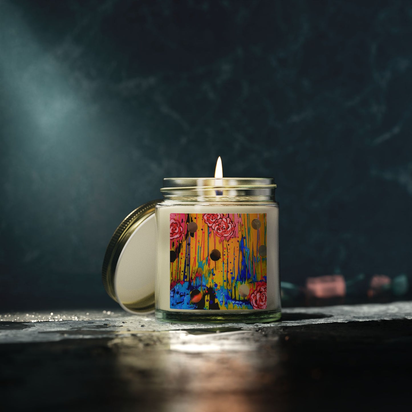 Candle in a glass jar with a colorful label on a dark background