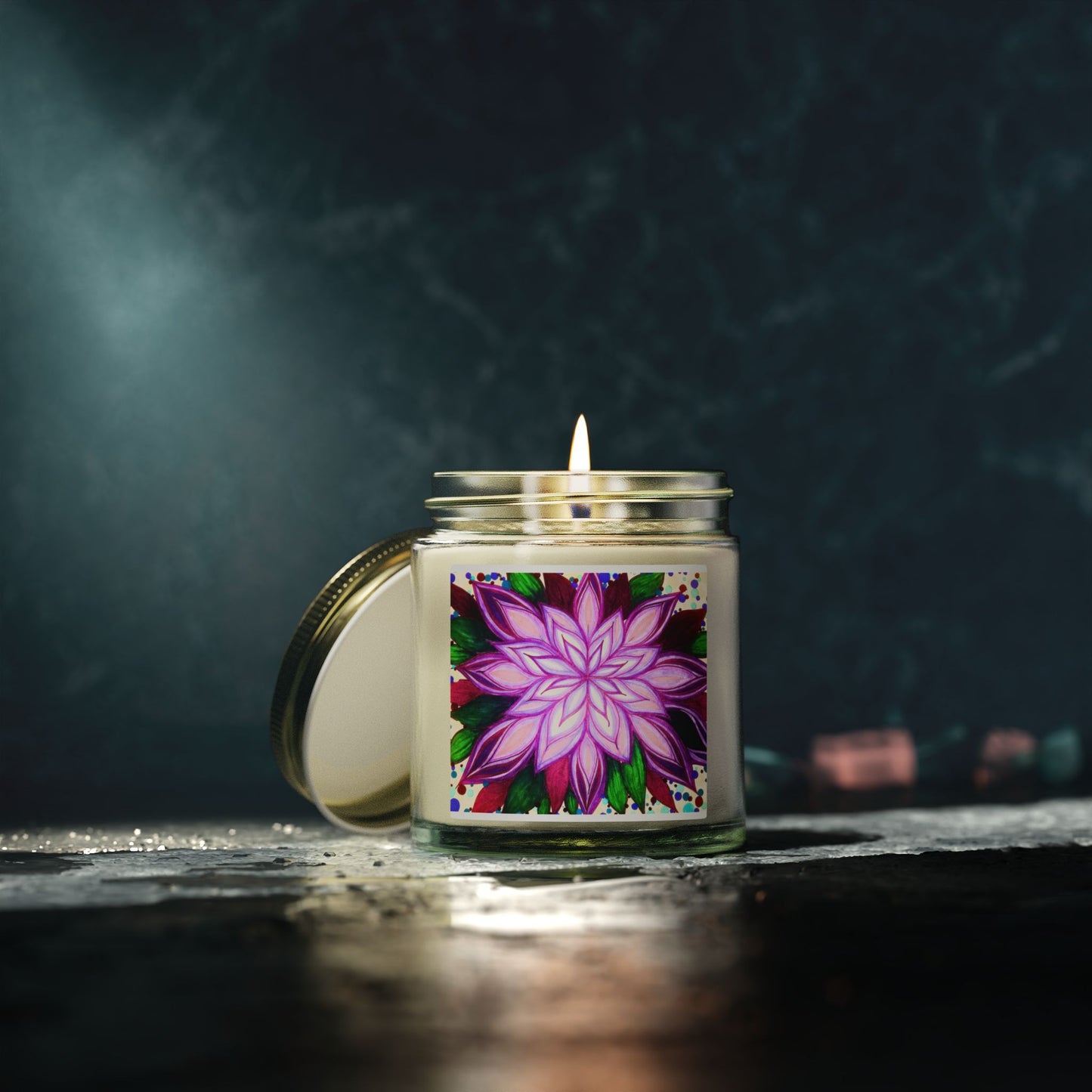 Candle in a glass jar with a colorful flower label on a dark background